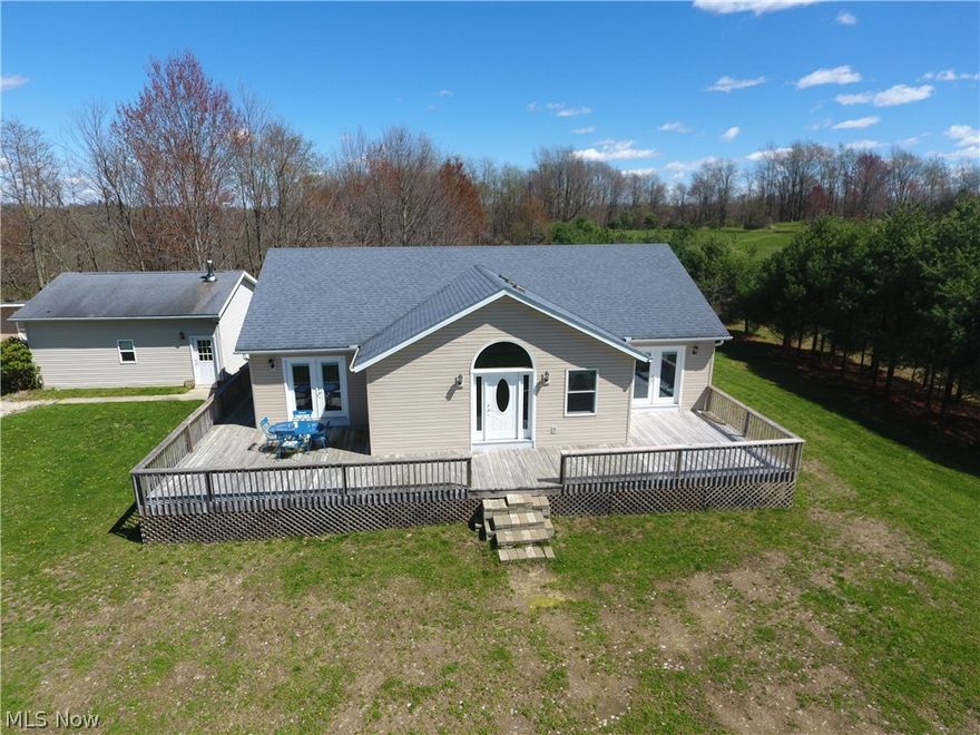 Over 15 Acres of Land with a Newer Ranch home & Two Car Garage.  The house features two bedrooms (potential for a third), three full bathrooms, a large open eat-in kitchen with numerous cabinets and plenty of countertop space.  The Bedrooms both have French doors that lead to the wrap around deck with a view of the pond.  The Master Bathroom has His and hers sinks and His and hers walk-in closets.  The Great Room has a Rustic Fireplace and mantle with Vaulted ceilings and an open floorplan to the Eat-in Kitchen.  The Basement has an outside entrance as well as inside. There is a mostly finished 11'3"x10'10" Room that could easily be finished into another bedroom and a Full bathroom next to it.  The basement has a large area of approximately 900 sqft of unfinished area. It also has a large crawl space for easy access & additional storage space.  The Home has a Dual fuel heat pump/propane for its main source of heat and a wood burning furnace as second option for low cost heat.  There is a water conditioner and Aquasure water filtration system in the basement to filter the water. The 24'x24' detached garage has a convenient half bathroom, concrete flooring, wood heat, electric and water.  The Land features just over 15 acres with a pond for fishing, a creek with small waterfalls, and mostly wooded area perfect for hunting. The well planned trails have been cut out with some ditches to minimize erosion and easy access through the wooded acreage. The timber includes numerous walnut trees.