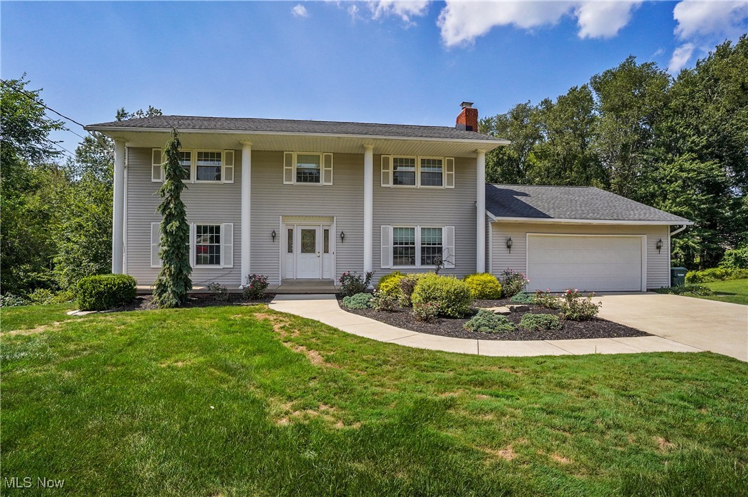Stately Colonial in Green Local School District. Don’t miss your opportunity to own this nicely updated 4 bedroom, 3.5 bath home with large in-ground pool in a quiet, private cul-de-sac setting. Welcoming front porch highlighted with grand, architectural columns set the tone for this classic home. Spacious foyer with large coat closet leads to bright yet cozy living room with huge windows and brick wood burning fireplace. The spacious kitchen has been recently updated with cherry cabinetry, granite counters, tile backsplash and floors, stainless steel appliances, under cabinet lighting, slider to large Trex deck, and functional center island. The dining room sits nearby featuring classic wainscotting and adding a subtle touch of elegance. Spacious family room with windows on both ends seamlessly connects the entire first level with a versatile and practical layout. Large closet, bench seating, half bath, and 2 ½ car garage complete the first floor. The second floor features the master suite, which includes two WIC’s and a full bathroom featuring dual sink vanity, tiled shower with glass door, and tile floors. Three more generously sized bedrooms with ample closet space and a full bath with dual sink vanity and jacuzzi tub complete the second floor. Lower-level walkout features carpeted rec area, bathroom with shower, laundry space and unfinished storage area. The secluded hot tub room features wooden walls, floors and ceilings, recessed lighting and exhaust fan. The exterior of this home is where the fun happens! Enormous, kidney shaped pool with salt water, diving board (10 ft deep) and cement surround with terraced landscaping, pool shed for equipment and plenty of space for entertainment! Summer is almost over! Don't miss your chance to squeeze in one more moment of fun and sunshine in your own personal backyard oasis today!