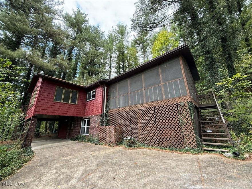 Peace and tranquility abound in this charming raised ranch home at Tappan Lake.  2 bedroom, 2 bath brick and vinyl home with walk out lower level.  Open floor plan with beautiful hardwood floors.  Stone wall in the living room with wood burner.  Cherry wood island in the kitchen with breakfast bar.  French doors in the dining room lead to the relaxing screened porch.  Vinyl replacement windows.  Spacious 23 X 16 deck provides ample space for entertaining and overlooks the scenic woods.  Concrete driveway with carport and EV charger.  8 X 10 storage shed.  New metal roof and new vinyl shakes in 2024.  Fiber optic and 5G service available.  Includes a dock on the water.  MWCD lease fee for 2025 is $2,104.