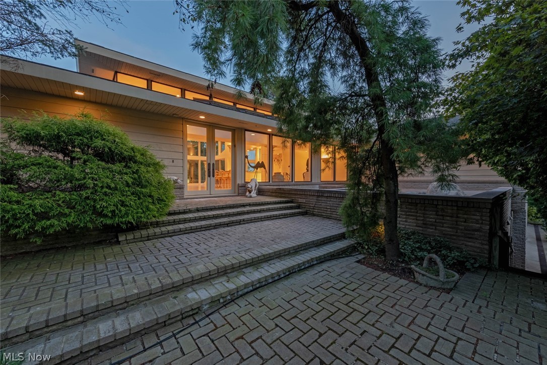 Prepare to be delighted by this exquisite Bialosky-designed estate on 15+ acres overlooking the Chagrin Valley! Lined with fruit trees, the private drive winds up the hillside to welcome you home, where you are greeted with a waterfall, lush landscaping, and a stunning front entrance. Step inside to enjoy soaring ceilings, walls of windows, and incredible amenities. The striking great room boasts a curved fireplace wall, a wet bar, and panoramic views of the backyard. The banquet-sized dining room flows into the spacious eat-in kitchen and hearth room. You will love the stone fireplace, built-ins, and glass-walled morning room. The luxurious master suite includes a private sitting area with a fireplace, a spacious bedroom, his and hers walk-in closets, a gorgeous en suite, and an office. You will enjoy a private stairwell to the lower level exercise room, where you will find a sauna and a hot tub. The walkout lower level also includes four bedroom suites and a family room with a kitchenette that walks out to the patio and in-ground pool. Other highlights include a private guest suite, an office, a four car garage, and a gazebo that overlooks the pool. Situated at the top of a gorgeous knoll, this home provides incredible privacy without sacrificing convenience. It is minutes from area shopping and dining destinations, metroparks, and highways. Do not miss this exceptional property!