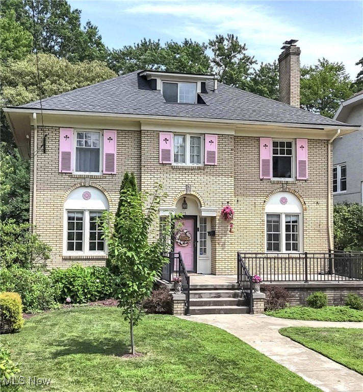 Prepare to be moved! Welcome to 215 Casterton Ave, a charming 2,770-square-foot Colonial located near Highland Square’s cultural landmarks, this 4-bedroom, 2.5-bathroom home blends vintage charm with thoughtful updates, creating a warm and inviting retreat in one of Akron’s most beloved neighborhoods. A generous foyer—large enough to function as a mudroom or welcoming entry hall—sets the tone for the home’s classic style. Hardwood floors, abundant natural light, and a stately fireplace define the spacious living room. The dining room, framed by elegant French doors, combines sophistication with warmth, ideal for both entertaining and everyday family meals. A versatile butler's pantry connects the dining room and kitchen, offering additional counter space, built-in storage, and flexibility for a hobby room, office, or play area. The kitchen itself is bright and well-appointed, featuring stainless steel appliances, plentiful cabinetry, and room to create and gather. Upstairs, the primary bedroom is a spacious retreat. A full bath with a dual vanity and three additional bedrooms provide comfort, convenience, and flexibility for family and guests. The finished third-floor serves as a versatile flex space or makes the ideal home office with a split unit for heat and A/C and conveniently connects to a second full bathroom with a classic clawfoot tub—an ode to the home’s early 20th-century roots. Enjoy quiet evenings outdoors on the expansive front porch, taking in the lush, lovingly maintained flower beds—featuring seasonal blooms like peonies, hydrangeas, roses, and even a young peach tree. The shaded, partially fenced backyard offers space for recreation, gardening, or relaxation. A two-car attached garage and paved drive offer convenience to residents and guests. A short walk from Highland Square’s shops, cafés, Mustard Seed Market, and the historic Highland Theatre, this home is a rare blend of enduring architecture, neighborhood charm, and modern-day comfort.