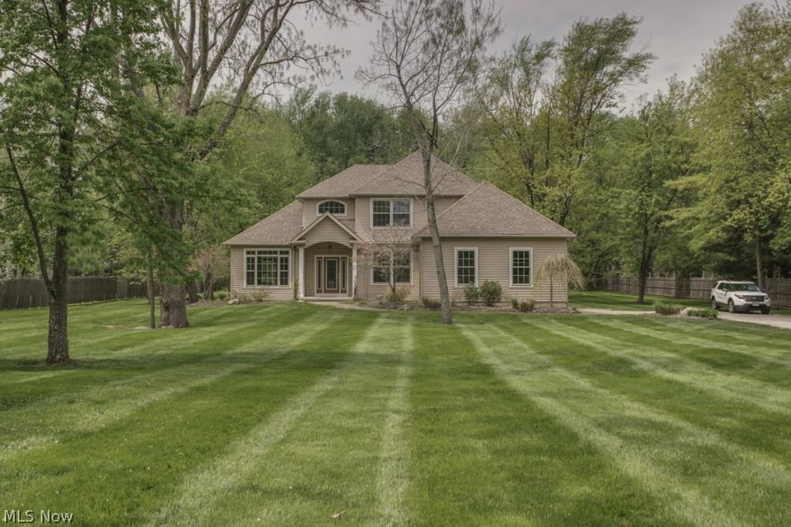 Absolutely gorgeous 2 story on a 1.4 acre lot. Open and spacious floor plan, shows like new construction!! 2 story great room with a wall of windows overlooking the private lot. Custom maple kitchen with stainless steel appliances. Rich hardwood floors throughout the first floor. Two story foyer, stately columns and an open wrought iron staircase add to the upscale design. Nice master suite includes a glamour bath with beautiful tile work. Full basement, side entry garage and so much more! Absolutely must see!