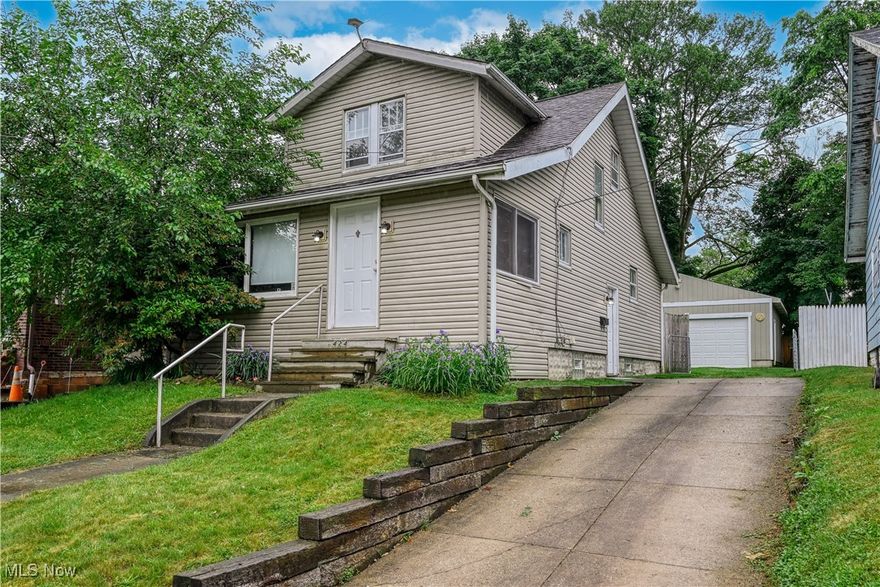 Welcome home to this spacious and updated 2 bedroom cape cod! Full of updates and charm and located just minutes from the Ohio & Erie Canal Towpath Trail and the Portage Lakes.  Starting from the enclosed front porch with peaceful view of the street, to the spacious living room that flows to the formal dining room with built ins, this home is sure to please. The updated kitchen with appliances has sliding doors that lead to your private backyard retreat, fully fenced with canopy that stays and oversized 2 car garage for all your mechanic or man cave dreams. Continuing back inside to the second level with both bedrooms, generous in size and the updated bathroom to complete the finished living spaces.  The full open basement has plenty of space to complete the perfect rec room, office or storage space.