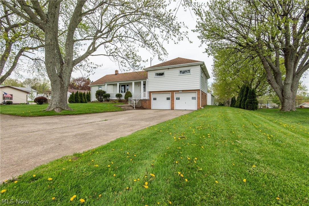 SPACIOUS SPLIT LEVEL IN PERRY TOWNSHIP! In the living room, you'll find wood floors, built-in shelves, neutral decor and a picture window that fills the room with natural light. The dining room features a vinyl floor and sliding glass doors that lead to the deck overlooking the back yard. Open to the dining room is the kitchen which features oak cabinets, a kitchen island, black appliances, and Formica counters. The full bathroom on the main level features linoleum flooring and neutral colored walls with white tile surrounding the tub. Upstairs, the master bedroom is carpeted and features 2 good sized closets. Each additional bedroom is carpeted. The full bathroom on the 2nd floor has a stand up shower and a newer vanity. The basement features new plumbing and glass block windows. The outbuilding is great for entertaining and fully finished with linoleum floors, paneled walls, a wood burner, and also features a deck that overlooks the back yard.