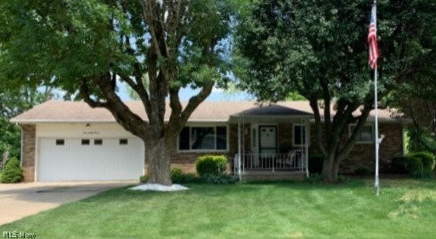 THIS CANTON SOUTH RANCH HOME WILL CHECK EVERY BOX ON YOUR LIST!!  A spacious covered front porch greets you the minute you start up the sidewalk and sets the tone for this perfect family home.  Once inside, you immediately notice the fresh paint in today's colors & brand new carpet in the generously sized living room, dining room and throughout the hallway.  The living room leads into a fully applianced kitchen and dining room open concept perfect for family gatherings.  Kitchen has plenty of counter and cabinet space with a pantry housing roll-out shelving.  Dining room door leads to quaint outdoor patio.  Off the hallway you will find a full bath, master bedroom with en-suite full bath, first floor laundry room and remaining 2 bedrooms.  All bedrooms and living room have hardwood flooring under carpeting.  The garage which is conveniently located off the kitchen provides access to a spacious screened in back porch and access to lower level rec room (electric fireplace works), storage