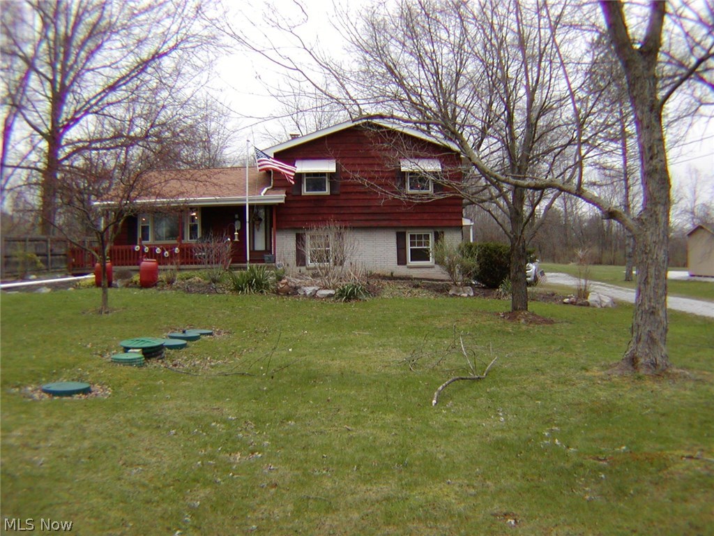 LOT: 100 X 335. Spacious 4 bedroom 4 level split. Newer septic system, newer replacement windows in most of the house. Vaulted ceiling in the living room. Dining area plus large breakfast bar. Hardwood floors under carpet in living room & 2 bedrooms up. Security system that includes fire alarms & police. $54 a quarter. 5 ceiling fans. Enclosed sun room off the dining area. 3 car attached garage plus 24 X 30 detached garage/ out building. Central air about 2 years old. Gas fireplace in the family room. America's Preferred Home Warranty included.