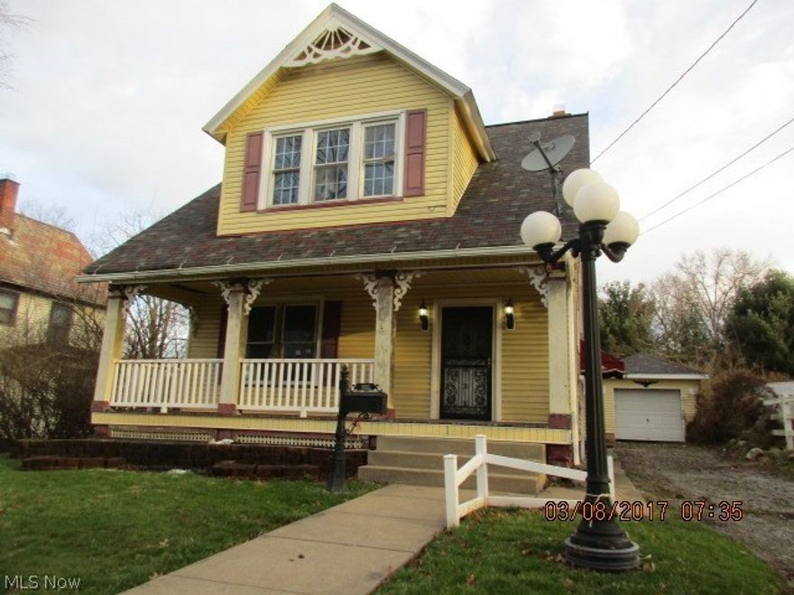 Charming 2 bedroom home with lots of natural woodwork, covered porch , fireplace & detached garage.