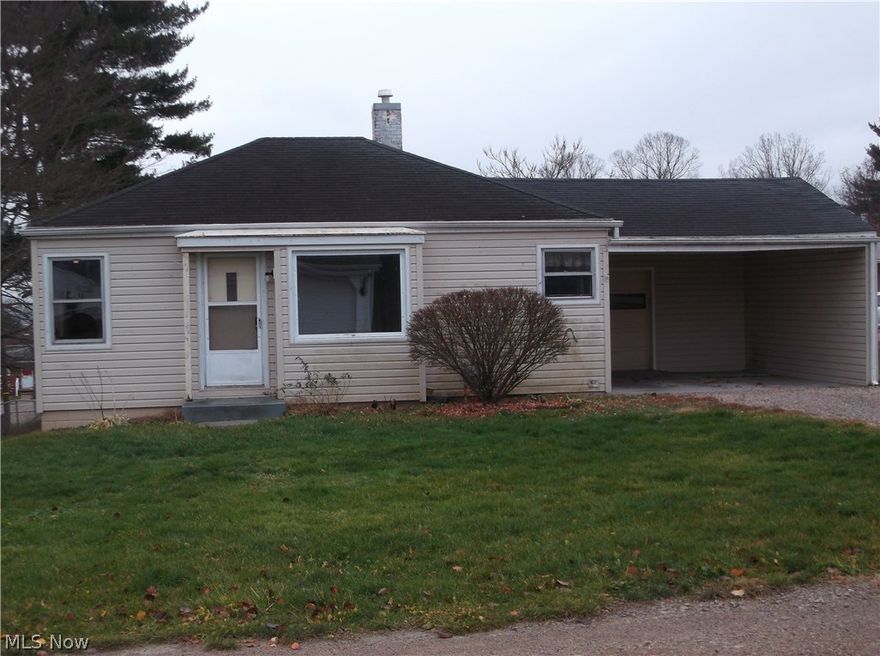 Why rent when you could make this your dream home? This 2 bedroom, 1 full bath home just needs minor finishing touches to be adorable.  As a one-floor plan home, it offers hardwood floors and a nicely lit large living room/dining room combination with picture window.  The kitchen has original oak cabinets with stove and refrigerator.  The first floor bath has newer tub walls.  A full walkout basement could be used as additional living space or additional storage area with washer/dryer hookup.  A covered carport or porch area provides outdoor space out of the weather.  It also has a one-car garage and large fenced-in yard and is outside the city limits.  Come check this one out by scheduling your appointment to tour!