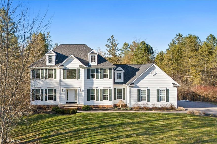Immaculate Colonial set on 2.5+Private Wooded Acres in Munson Twp! This beautifully updated and spacious home boasts over 3800 finished sqft of living space with 4 Bedrooms, 2 Full Baths, 2 Half Baths, freshly painted interior and desirable floor plan. 2-Story Foyer entrance welcomes you to both Dining Room & 1st floor Home Office. Bright and light Family Room with gas fireplace and open to the recently updated Kitchen with new custom cabinetry, granite counters with breakfast bar, fixtures, recessed lighting, appliances & vaulted Dining area with access to deck. Vaulted Master Bedroom Suite with walk-in closet & Glamour Bath with his & hers vanities, jetted tub & separate shower. 3 additional Bedrooms with full bath to share complete the second floor. 1st floor Laundry Room and half bath. Full finished lower level includes Rec/Media/Play Room with half bath, walk-up access to garage or walk-out to patio & fenced-in area for pets or play area for kids. New Roof installed 2024. Pella windows installed 2022. Enjoy entertaining this summer on the expansive composite deck overlooking deep backyard. Situated in quiet community....this home is surrounded by mature trees with beautifully landscaped yard and manicured beds full of lush plantings. Paved drive, 3+car attached garage. Ideal home for the growing family....Must see to appreciate all this home has to offer inside & out! Close to Geauga Parks, NDCL, Alpine Valley, YMCA, UH Geauga Hospital and just minutes to Chardon Square!