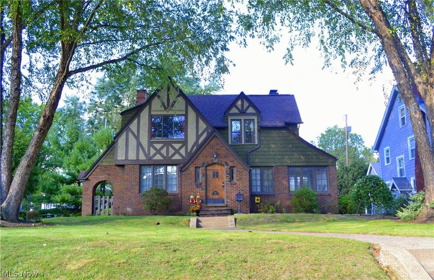 Beautiful Colonial Tudor situated on a double lot in Canton’s Historic Ridgewood Neighborhood. Recently relandscaped open side lot is great for families, entertainment, or future additions. Newly refinished wooden front door. Freshly painted, large, and recently updated kitchen with dinette area. Newer stainless steel appliances. 1st floor laundry in freshly painted full bath right off of  kitchen. 24 x 24 extra large 2 car attached garage with 2 garage door openers. Freshly painted sun room that could double as a den or office. Lots of natural light on both lower and upper levels. Redesigned and newly painted master bedroom with walk in closet, cathedral ceilings, wood truss beams, and carpet. All secondary bedrooms are large with 1 having natural hardwood flooring and the other 2 with carpet.  Built in storage on second level. Recently carpeted rec room. Newly installed 2017 Water Softener. Heating and cooling are zoned with heat pumps upstairs and downstairs. Gas heat downstairs wit