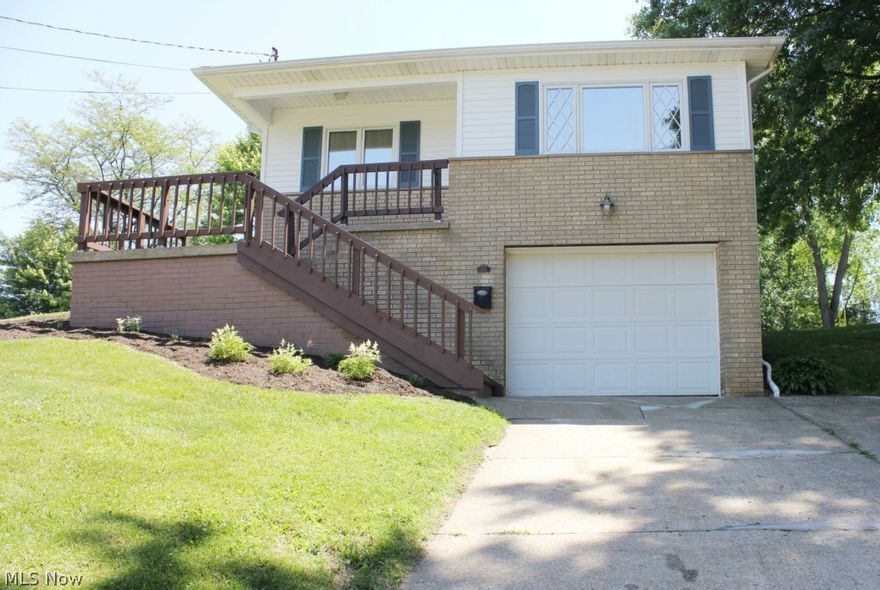 Situated on three parcels, this beautifully updated ranch in Ellet is just waiting for its new owner.  Move in with nothing to do but enjoy the summer!  Refinished hardwood flooring throughout first floor.  Redesigned, updated & spacious kitchen features new island/breakfast bar, porcelain flooring, countertops, backsplash, SS appliances, & hardware.  Totally updated full bath.  Partially finished basement offers two rooms with canned lighting & nice closet space.  This additional square footage can be used as an exercise room, office, rec room, or whatever fits your needs.  Sliders from the master bedroom lead to a 12 X 12 deck for enjoyment of the backyard.  Pella windows and newer furnace.   Lighting fixtures & landscaping new in May 2014.