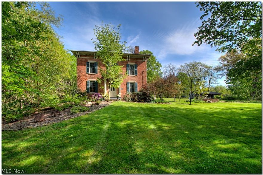 Unique opportunity to own a historic home on 11.15 wooded acres with stream!   This beautiful brick Italiante Victorian built by the original Wayne County Corner, with materials harvested from the land surrounding the home, features 10 ft. ceilings and ash floors on 1st floor, 9 ft. ceilings on 2nd floor.   Recent modern upgrades include updated wiring, new kitchen with granite countertops and Armstrong ceiling, Andersen Architectural Collection windows, fresh paint throughout, new period correct light fixtures, 2 updated baths.   Zoned heating with natural gas furnace for first floor, attic mounted furnace and a/c for 2nd floor.   Free Natural Gas!   3 stall horse barn.   Great location minutes from Rt. 21 and I-76, 25 minutes to Akron.