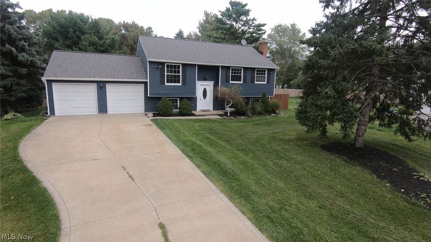 This newly renovated 4bedroom, 2full bath home has everything to make you feel at home.  All new paint, light fixtures, hardwood flooring and carpet throughout! The upper level’s open floor plan is great for entertaining. The kitchen includes all new custom cabinets, tile backsplash, granite countertops, and stainless steel appliances. On the lower level there is a lovely family room featuring a brick fireplace, a laundry room, and possible fourth bedroom or office and a full bath. The exterior of the home is freshly painted and offers a wood deck, a concrete patio, new landscaping and privacy! This home is completed with NEW AC and Hot Water Tank, a newer roof, and a two car attached garage. Schedule your private showing today! Check out the 3D Tour!