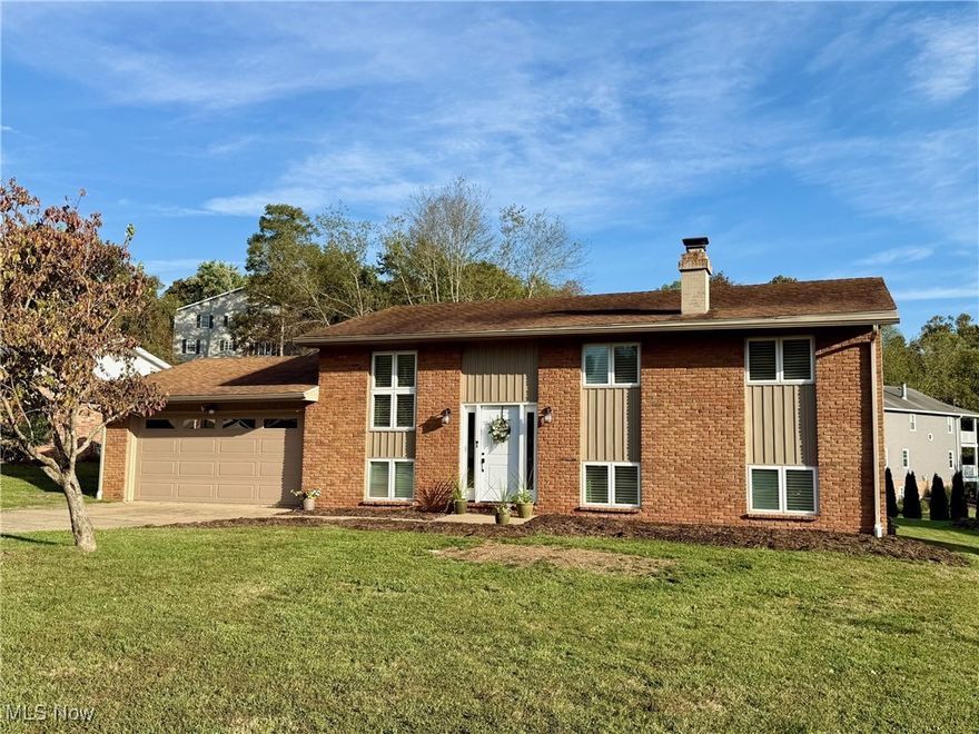 Welcome to this beautifully updated brick and vinyl home located in a desirable and well-established neighborhood.  Featuring 3 bedrooms and 2 full baths, this home offers modern comfort with timeless appeal.  Step inside to discover attractive new LVT flooring throughout, new Pella windows, new HVAC, new 200 amp service, new interior and exterior doors and trim, new custom blinds, updated baths and more!  The heart of the home boasts a kitchen with new countertops, stainless steel farmhouse sink, counter-depth refrigerator and a 36" range.  Exit the dining area via a brand new sliding door and relax on the large, covered rear deck overlooking the expansive level backyard.  Unique brick sidewalks lead to a firepit area ideal for cozy evenings and gatherings.  The lower level offers a generous family room with a charming gas log brick fireplace and a cozy game nook tucked behind with a full bath with a 4' shower nearby.   An additional office/multipurpose room adds flexible space and the large laundry/utility room as storage room as well as the attached 2 car garage.  Located near the end of the cul-de-sac on a dead end street and only a few minutes to downtown this move-in ready home won't  last.  Make your appointment to view today!