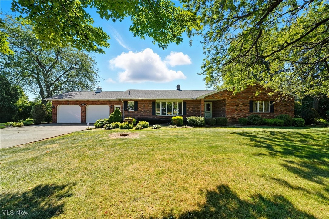 Brick Beauty! 2,200+ square foot 3 bedroom 2.5 bath home with large open and airy rooms, eat-in kitchen that offers a breakfast bar, all appliances and dining area. Formal dining room, spacious living rm w/bay window, step-down family room that boasts a wood burning fireplace and sliders to the private concrete patio in the back yard! An ideal spot to entertain and relax after a long day! The Primary bedroom is more than large enough to accommodate a King sized bed and comes with a private bath and walk-in closet. 2 car attached garage w/ electric openers, a basement that is high and dry plus added storage space is available in the well lit concrete crawl space. Newer roof, garden/tool shed, concrete drive, located across the street from Lake Erie and set in a prime location!