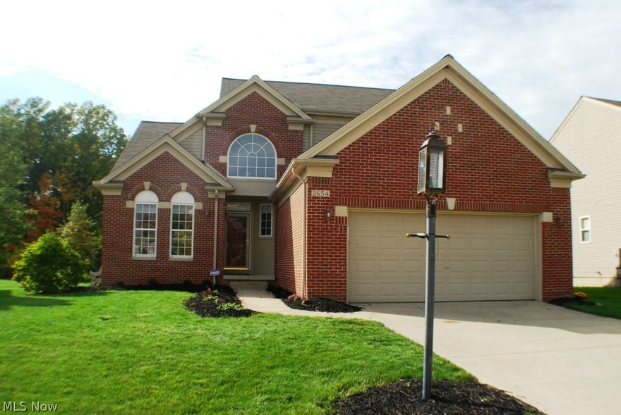 Be the first to call this great value in the sought after Bentley Park subdivision your home.  This few and far between, first floor master plan with den and sunroom, is located on a premium wooded lot.  The bright kitchen comes equipped with all appliances staying, upgraded cherry cabinets, hardwood floor, and Corian counters.  The open floor plan of the dining room, family room, and sunroom, make it perfect for entertaining or everyday living!  Dining room, Family room, and foyer also feature hardwood floors.  Fantastic finished basement with your own private movie theater including a projector and movie screen, recreation area (pool table negotiable), storage, work-out/play area, and a bathroom that has been plumbed for the addition of a shower if you see fit.  Upgraded lot backs to woods, making this a rare opportunity to enjoy a private backyard with large stamped concrete patio for outdoor living/entertaining space.  Generous room sizes through-out the home, along with the added