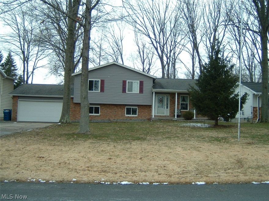 Spacious, 1868 sq.ft., Four-Level Split design on a 82x200 lot, in a quiet, low-traffic, desirable location. Brick and Vinyl exterior. Vinyl windows throughout. Crown molding in every room. Treated wood deck is 12x16. Huge rear yard. Attached double garage. Concrete driveway. Beautiful Hardwood floors on the main level. Living Room with leaded-glass front door. Dining Room with chandelier and double door access to the rear deck. Totally updated kitchen with Kraft Maid white cabinetry, granite counters, glass mosaic backsplash, recessed lighting, quiet-close drawers, microwave, gas range and dishwasher are included. Three large Bedrooms and a full, updated Bathroom with a pullman door into the MBR on the upper level. and there's also ewer carpeting and luxury vinyl hallway flooring (2017). Lower level, huge, 16x23 Family Room with wood blinds, carpeting and a gas fireplace. Full, updated Bathroom with shower.  Basement level Rec Room is 12x20, with a high ceiling and carpeting. Utility/