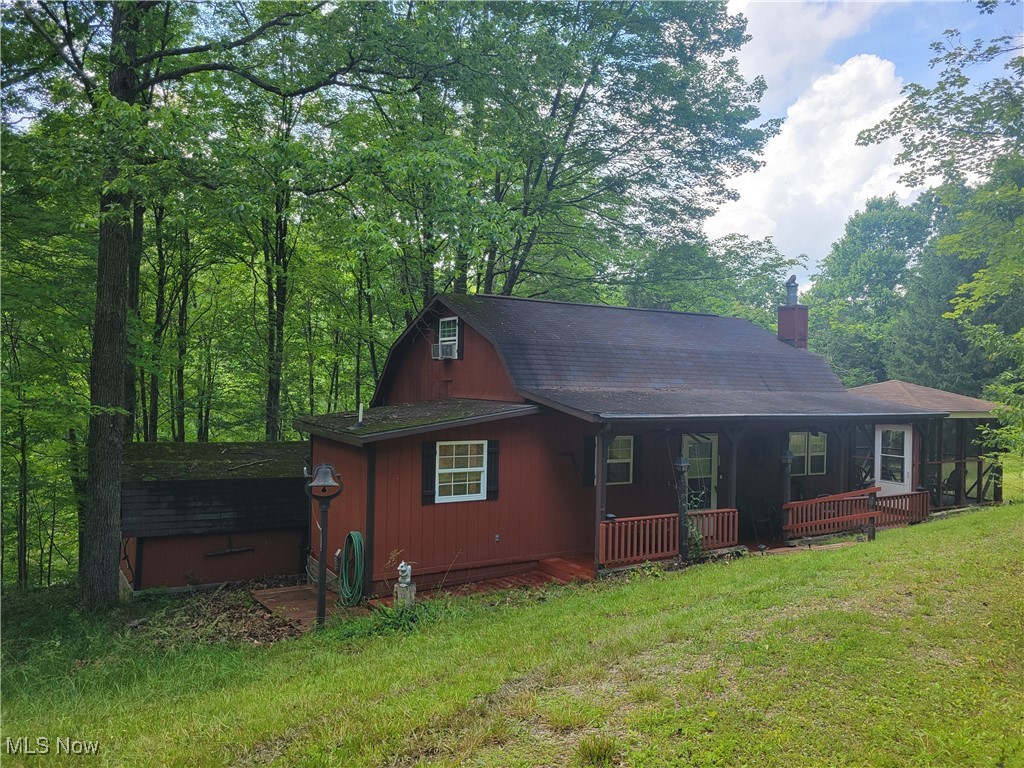 Peace, Quiet and Privacy??? Just 15 minutes from Tappan Lake, This property offers it all. Adorable 3 bdrm , 1 1/2 bath cabin on 3+ acres, minutes from Tappan Lake and on private ground. The loft area has space for 3-4 beds. Kitchen has all appliances, bar stools and peninsula with plenty of seating. The living room has a wood burner to keep you cozy on the cool evenings and propane heating if needed. Stay for the summer, vacation on weekends or make this your year round home. Listen to the birds while enjoying your morning coffee or your evening refreshments outdoors yet inside the screened, 15' x 15' picnic shelter. Spend evenings around the fire pit relaxing with friends and family. A large 22' x 32' garage provides space for a work area, room for your vehicles and overhead storage for your kayaks, fishing or hunting equipment. There are 2 extra outbuildings for tools and extra storage for your other outdoor toys. Furnishings, washer/dryer, some kayaks, and many others items to be included if desired. New septic approved and to be installed prior to close, aeration system. Call today for your private showing. This won't last long.