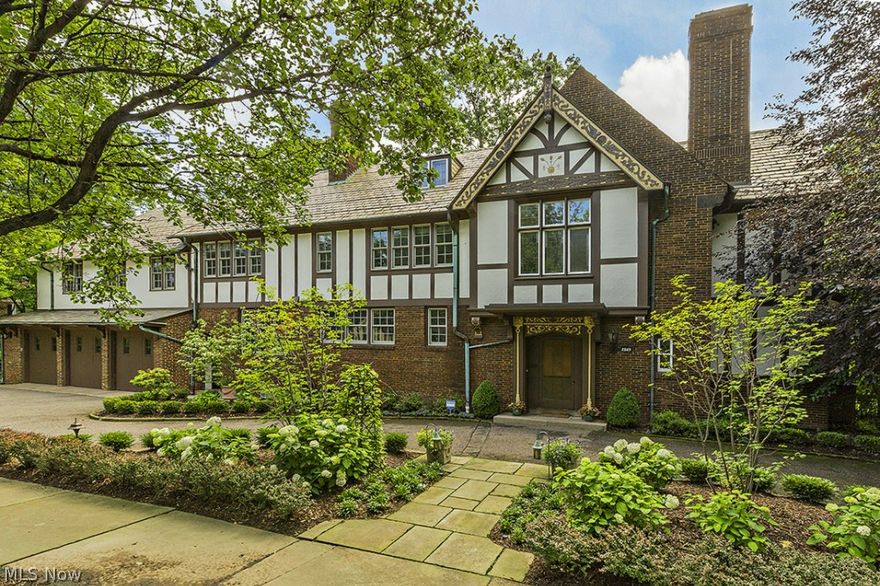 Historic Euclid Golf Tudor Situated On Professionally Landscaped Double Lot. Stunning Original Architectural Details Through-Out, While Restored & Remodeled For Today's Lifestyle.  Fabulous Floor Plan For Entertaining with Great Indoor & Outdoor Spaces.   The 2 Story Foyer Opens To The Living Room & Library, Both with Detailed Plaster Moldings & Fireplaces.  A Screened Porch Off The Living Room Starts The Outdoor Entertaining Spaces & Accesses Two Private Stone Patios. The Formal Dining Room Has Floor To Ceiling French Doors That Opens to The Patio Creating A Perfect Flow For Entertaining.  The Spacious Custom Kitchen Features A Center Island, High End Appliances &  A Separate Eating Area.  A Mud Room Breezeway Connects The 3 Car Garage. The Master Suite Has A Fireplace, Large Sitting/Sun Room, Remodeled Bath & Connecting Dressing Room. 3 Additional Bedrooms & 2 Full Baths Complete The Main 2nd Floor.  The 3rd Floor Showcases A Cozy Theater Room Plus 2 Additional Bedrooms & Full Bath.