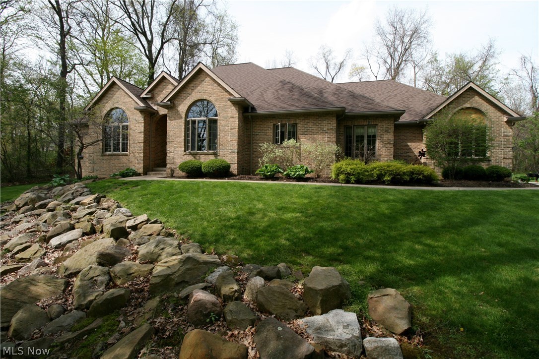 Must see! This one of kind all brick ranch sits 300+ feet off the road on a 5 acre wooded lot, creating a private and relaxing feel. A paved drive takes you up to the 3 car garage. Step inside and see the beautiful oak cabinets, floors, and trim. Off the kitchen is a breakfast nook, and the other side sits beside the faulted-ceiling formal dining room with stunning views out of Anderson windows. The living room boasts 15ft ceilings, has a wood burning fireplace and provides access to your back serene patio. Master suite sits away from the other bedrooms with a large bath, including a whirlpool tub and shower, his and hers sinks with a huge walk in closet. There is even room for an office or 4th bedroom, your choice. All bedrooms have walk in closets! 13 course basement ready to be finished with rough in for a full bathroom. High efficiency furnace. Gutter toppers. First floor laundry. This home was built to provide easy and efficient living. Don't let this fantastic home get away.