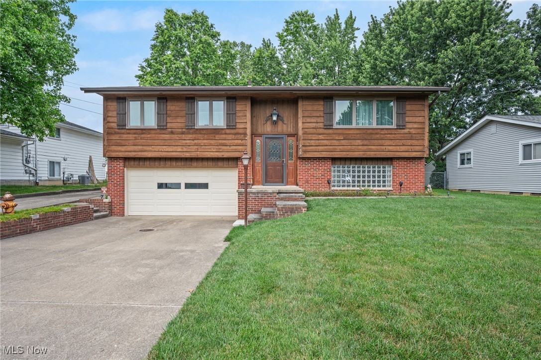 This well-maintained and spacious one-family-owned, cedar-sided Bi-level home is located on a quiet street in Northfield and offers over 1,854 living sq ft, 3 bedrooms, one full, and two half baths. The home features well-cared-for hardwood floors, including parquet wood flooring in the living room and bedrooms. An eat-in kitchen includes all appliances and a dinette area, and an inviting family room has hardwood floors and a floor-to-ceiling brick surround gas fireplace. A second brick fireplace is woodburning with a gas starter and anchors a lower-level space perfect for entertaining, complete with a wet bar, beer keg fridge and tap, and barstools and barware included. An additional finished room on the lower level can serve as a rec room, hobby area, or home office. An oversized detached 2-car garage is perfect for a car enthusiast, woodworker, or hobbyist, with plenty of room for a workshop, storage, or project space. Combined with the home's attached 2-car garage and extended driveway/parking pad, there is no shortage of space for vehicles, tools, or toys. A back patio with concrete benches rounds out the tour. Recent updates include: Replaced all windows except front lower level glass block (2021), installed gas logs in main level fireplace (2022), installed a wall heater in attached garage (2022), and cleaned HVAC vents (2021). HVAC, plumbing, and electrical systems have been well maintained. INCLUDED are ALL kitchen appliances, freezer in basement, and washer/dryer. Conveniently located near OH-8, I-271, shopping, restaurants, parks, and other local attractions. Home is being sold AS IS.
