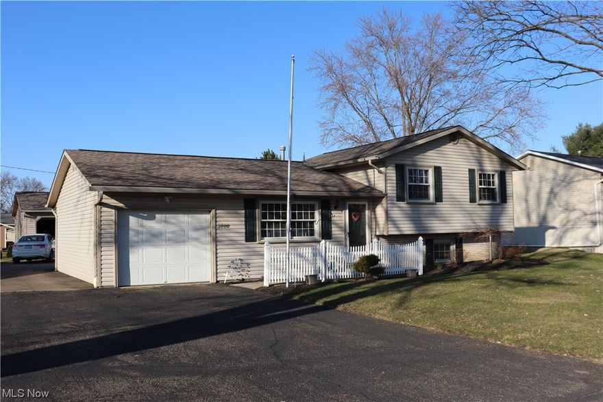 Welcome to this stunning split level located in Perry Township! Firstly, the exterior has a ton of amazing features! Not only does it have a large sunroom with access from inside and out, but it also has a composite deck, a one car attached garage, two car detached garage, and an enormous driveway! The interior of this home has a lot to offer too! The basement's finished, and includes access to the backyard! The hallway bathroom has been remodeled, and the living room and hallway offers fresh and soft carpet! The kitchen has new quartz countertops, and a brand new refrigerator! This home is calling your name!