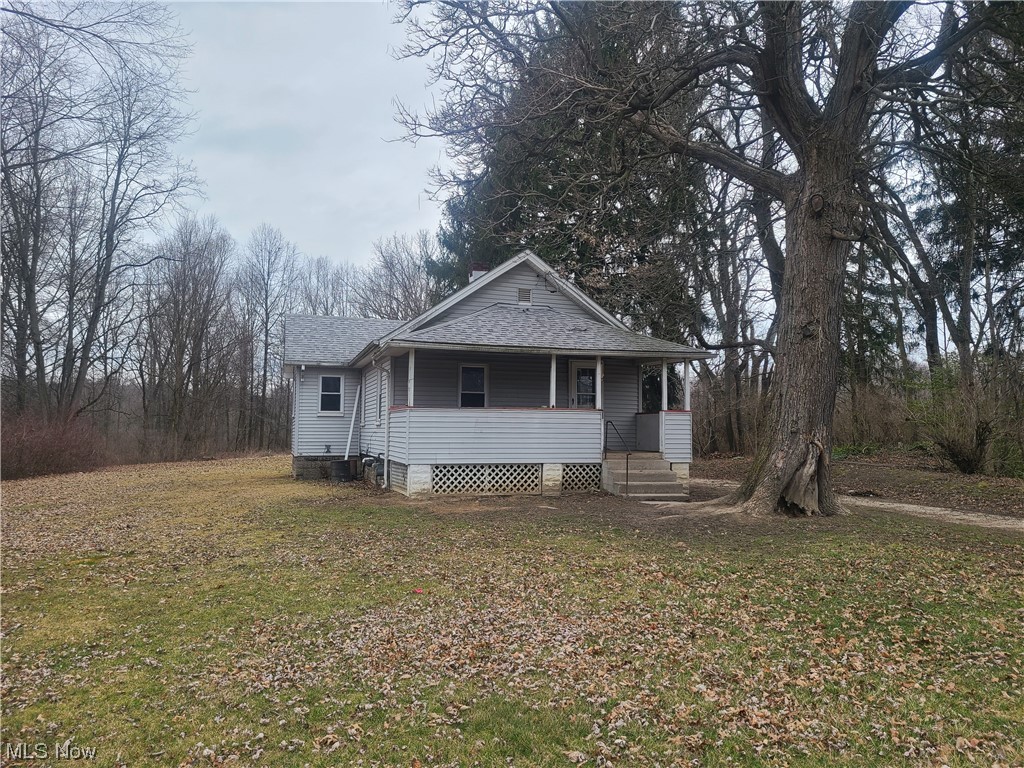 Welcome to a rare opportunity in Lordstown Village! Tucked away on a sprawling 1.13-acre wooded lot, this fixer-upper presents the chance to create your ideal retreat, starter home, or investment property. Situated in the heart of Lordstown and in close proximity to amenities such as local restaurants and the Lordstown library, this property is located where convenience meets serenity. Cleaned out and ready to be renovated, this home provides the perfect canvas to bring your vision to life. This ranch-style home features two bedrooms, a spacious living room, a full bathroom, and an eat-in kitchen. There is also a full, unfinished basement with a sump-pump and laundry hook ups. There is a full, covered front porch and a large, private backyard overlooking the woods. Don't miss out on the opportunity to transform this diamond in the rough into the home of your dreams!