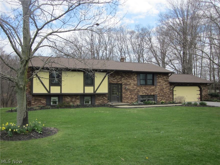 One of the most well maintained homes you will find with many updates! New electrical box, chimney re-pointed and new railing on the deck with fresh paint (2017). All new windows throughout, sliding glass doors with a lifetime warranty and roof (2013).  Master bath completely remodeled with double sinks and cultured marble counter-tops with large walk-in closet (2014) and main bath updated with ceramic tile floor, crown molding and more (2015).  Carpet in the living room and hallway and gutter guards (2010). Kitchen appliances, sink and counter-tops (2011).  Finished lower level with family room and rec room with full kitchen, sliding glass doors lead to patio and wonderful back yard.  Beautiful landscaping with lots of perennials to enjoy every year, winding crick and many trees on the property.  Home Warranty option available.