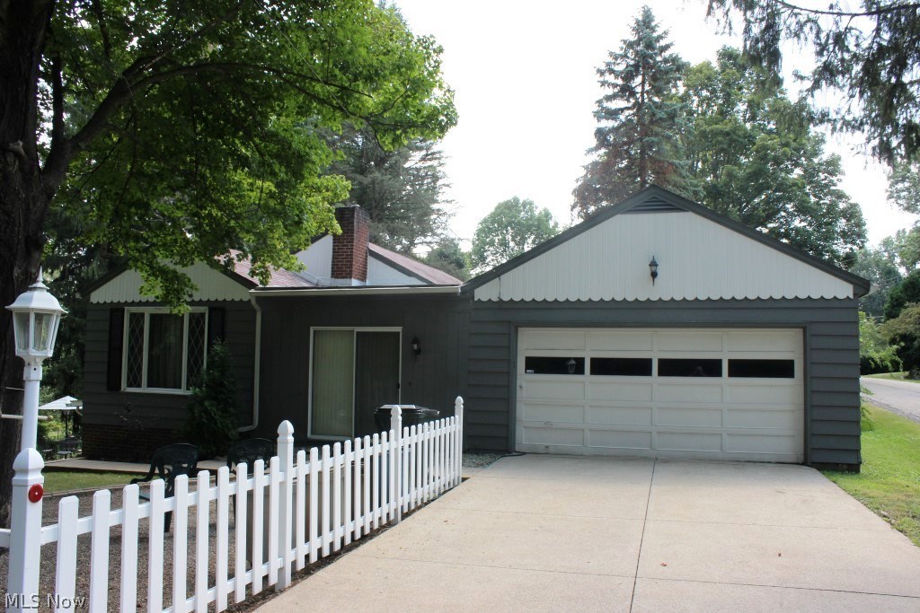 Lovely park like setting with water views & access on Nimisila Reservoir is this spacious 3 bedroom, 1.5 bath ranch with approx. 2316SF including finished walk out lower level, 2 car attached garage plus 1 car detached garage situated on private corner lot surrounded by state property on dead end street* Wood floors through out 1st floor except enclosed breezeway/sunroom* Family room with brick gas log fireplace with heatilator* Recreation room with 3 sliders to patio & back yard* Applianced kitchen (range, refrig & dishwasher)* Stack washer & dryer included* Glass block windows* Updated bathrooms, softener, hotwater heater, well pump, garage door & electrical panel* Additional insulation* New septic system, 8/2017* Tranquil private retreat* A must see!