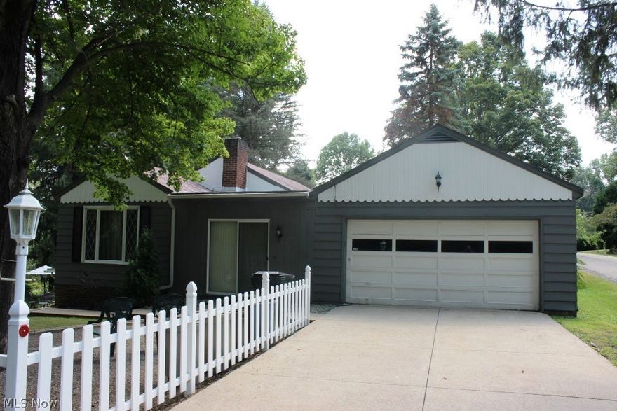 Lovely park like setting with water views & access on Nimisila Reservoir is this spacious 3 bedroom, 1.5 bath ranch with approx. 2316SF including finished walk out lower level, 2 car attached garage plus 1 car detached garage situated on private corner lot surrounded by state property on dead end street* Wood floors through out 1st floor except enclosed breezeway/sunroom* Family room with brick gas log fireplace with heatilator* Recreation room with 3 sliders to patio & back yard* Applianced kitchen (range, refrig & dishwasher)* Stack washer & dryer included* Glass block windows* Updated bathrooms, softener, hotwater heater, well pump, garage door & electrical panel* Additional insulation* New septic system, 8/2017* Tranquil private retreat* A must see!