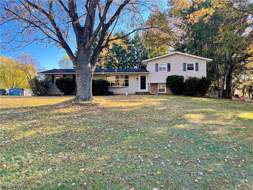 Beautiful split level home located in Tuslaw. This three bedroom home has many features and updates. Features include gorgeous hardwood floors throughout the home, large living room with bay window, large family room with fireplace, utility room, a patio that flows out into a scenic backyard, a large oversized 4 car garage with above storage and electric. Also home has a 2 car attached garage. Updates include drilled well 2019, hot water tank 2015, furnace 2022, windows, and a updated bath. Not to mention an additional lot. This home is a must see!