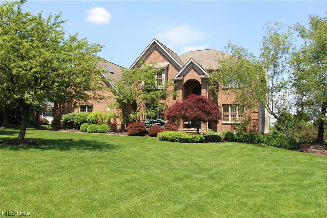 Breathtaking Custom brick 2-story with over 3600 sf of living space. Grand 2 story foyer leads to a spacious gourmet kitchen w/corian counterops, breakfast nook, center island and walk in pantry. The great room with cozy fireplace and an abundance of natural light leads to a two story deck which overlooks the back yard. The first floor also features 9' ceilings throughout, formal dining room, laundry, and office with built-in cabinetry. The 2nd floor features a master suite with walk-in closet, large bathroom with garden tub, double sinks and shower. Upstairs also includes an additional 3 bedrooms and full bath. The lower level is finished with a family room w/fireplace, work-out room, pool storage room, and convenient full bath which walks out to the 16 x 38 lazy L heated inground swimming pool with patio area. A 3 car garage and a beautiful setting put an exclamation point on this property!