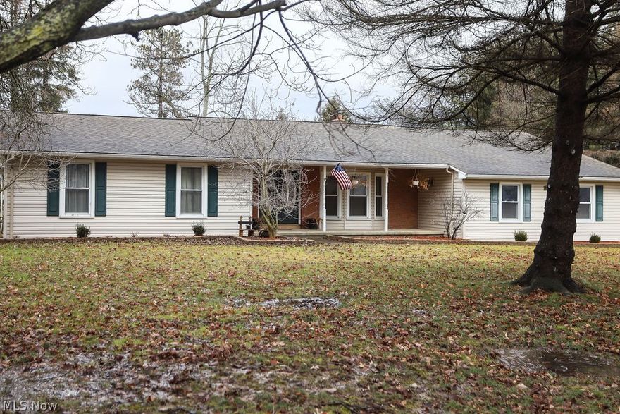 Must see ranch in New Springfield. Call now to see this beautifully updated home on almost 4 acres. Huge kitchen features Maple glazed cabinetry and gorgeous granite counters, large island and stainless steel appliances. The adjacent dining room is open to the kitchen and is a great space for entertaining.  Step down Living room with newer wood flooring, brick wall fireplace and beamed ceiling. This is a full four bedroom home. The newly redone master has a great walk-in closet, private bath, sitting area an  it opens to a secluded patio of it's own. 3 additional bedrooms and a large main bath for the family. Home has a powder room off of the 2 car side entry garage. Covered patio for outdoor entertaining or relaxing. Property also features a huge outbuilding/shop for storage, cars, wood shop or whatever your needs may be. Fenced pasture area for animals. This home has it all.. call for a private showing.