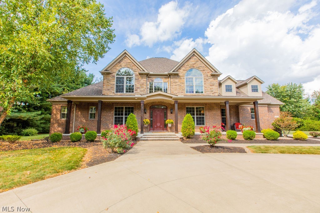 Welcome to this gorgeous home located in Sharon Center. Build with quality in mind, you will love the numerous features of this home for years to come. Home is tucked away on 2.8 acres surrounded by towering pines which provides the utmost privacy. Greet your guests under the covered front porch with cedar posts and enter the 2 story foyer. Tigerwood hw floors are found in the foyer, dining room & office. The kitchen reveals a wrap around counter, breakfast bar & additional island for all of your cooking needs. Granite countertops, maple cabinets & tile floor lend to the kitchens wow factor. A sunroom is off the kitchen. Plenty of space is found in the walk in pantry. The first floor LR makes doing laundry a breeze. The 2 story great room will be your favorite place to relax. A floor to ceiling stone wood-burning fireplace is found within a wall of windows. The primary suite is expansive and offers 2 walk in closets. The primary bath reveals an extra large stone shower, jetted tub & d