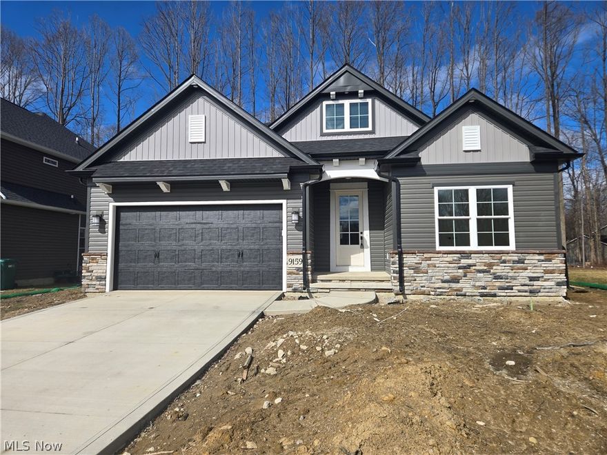 Experience the Spacious Elegance of the Tisbury Plan! Step into the inviting foyer where timeless design meets exceptional functionality. The grand entryway, highlighted by an open staircase, sets the tone for the quality craftsmanship throughout. At the front of the home, two generously sized bedrooms and a full bath offer flexibility that's ideal for guests, a home office, or a quiet study. The heart of the home is the open-concept kitchen, designed for the culinary enthusiast, featuring an expansive quartz island perfect for both meal preparation and entertaining. Custom cabinetry elegantly wraps around the island, providing abundant storage and a seamless flow into the adjoining great room. The great room is filled with natural light and anchored by a stunning tray ceiling and a custom fireplace, creating a warm and sophisticated gathering space. The main bedroom suite serves as a private retreat, complete with a luxurious bath featuring double vanities, a seamless tiled shower, and an impressive walk-in closet. Thoughtful details throughout include a first-floor laundry room with a custom drop-zone bench, as well as a conveniently placed broom closet. This home combines beauty with practicality at every turn. Discover the perfect blend of luxury, functionality, and tranquility in the Tisbury plan.