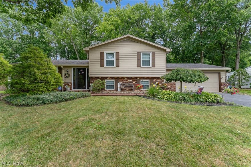 Discover the perfect place to call "home" in this fantastic three bedroom, two full bath Howland split level! Tucked away in the peaceful Sherwood Greens neighborhood, this extensively updated 1920 sq. ft. home has wonderful curb appeal and a great layout. Through the front door you'll be welcomed by the cathedral ceiling of the large open plan family room and dining area with french doors that lead to the back deck. The bay window provides ample natural light and you'll find new pergo flooring throughout the main and lower level. The renovated kitchen has an enormous pantry, a brand-new built-in microwave, a skylight and brick focal wall. Downstairs you'll find a huge family room with a cozy gas fireplace that is perfect for entertaining and another full bathroom with a great storage area. The upper level features three bedrooms with large closets and a beautiful full bathroom with porcelain flooring, which has access from the principal bedroom and hallway.  The sizeable backyard is a private retreat featuring a low maintenance rock border and tiered deck overlooking the tree lined border. The basement offers tons of storage and a laundry area with a new dryer. The attached oversized two-car garage has wall-to-wall pegboard and cabinets to easily store all of your gear. All of this is located minutes from Howland schools, Avalon County Club, and the Eastwood Mall shopping complex!