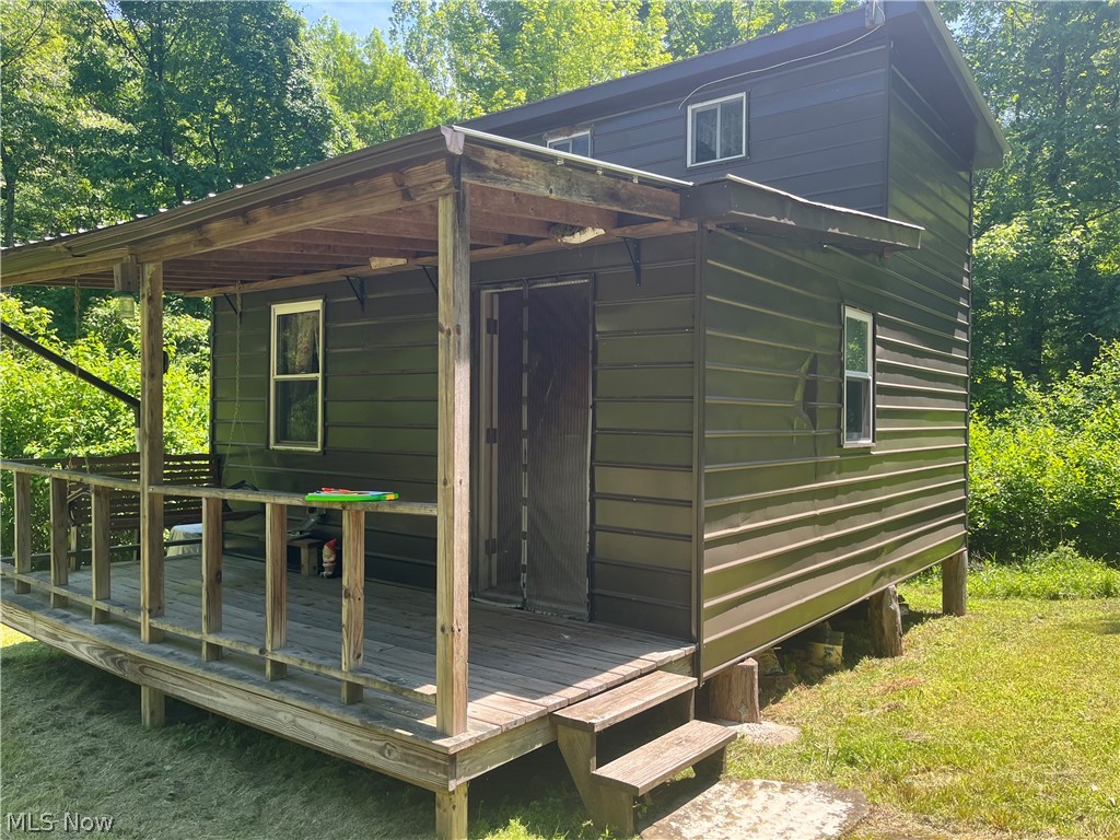 A little piece of paradise! Tucked away is the woods is this darling little one room cabin with a loft. All the conveniences of home without the expense of utilities. The cabin has solar panels on roof for electricity, Propane gas for heat & cooking, rain water barrel for water, and private outhouse for restroom. There is a bridge to cross the babbling creek and a long driveway to get back to the cabin which is situated in the center of the this 3.68 acre tract of land surrounded by trees. The gate is kept locked at all times. Please call for code. The agent must be present for all showings.