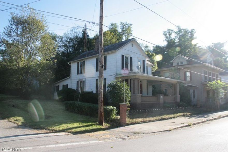 What a value! This charming older home is poised for a comeback. All rooms (except the kitchen and bath) are pretty much original. Original unpainted trim, doors banister greet you and give you the sense that this can be a stately older home. From the exterior you are greeted by a wrought iron fence leaded glass doors. Needs some work, but oh-boy is the value here!