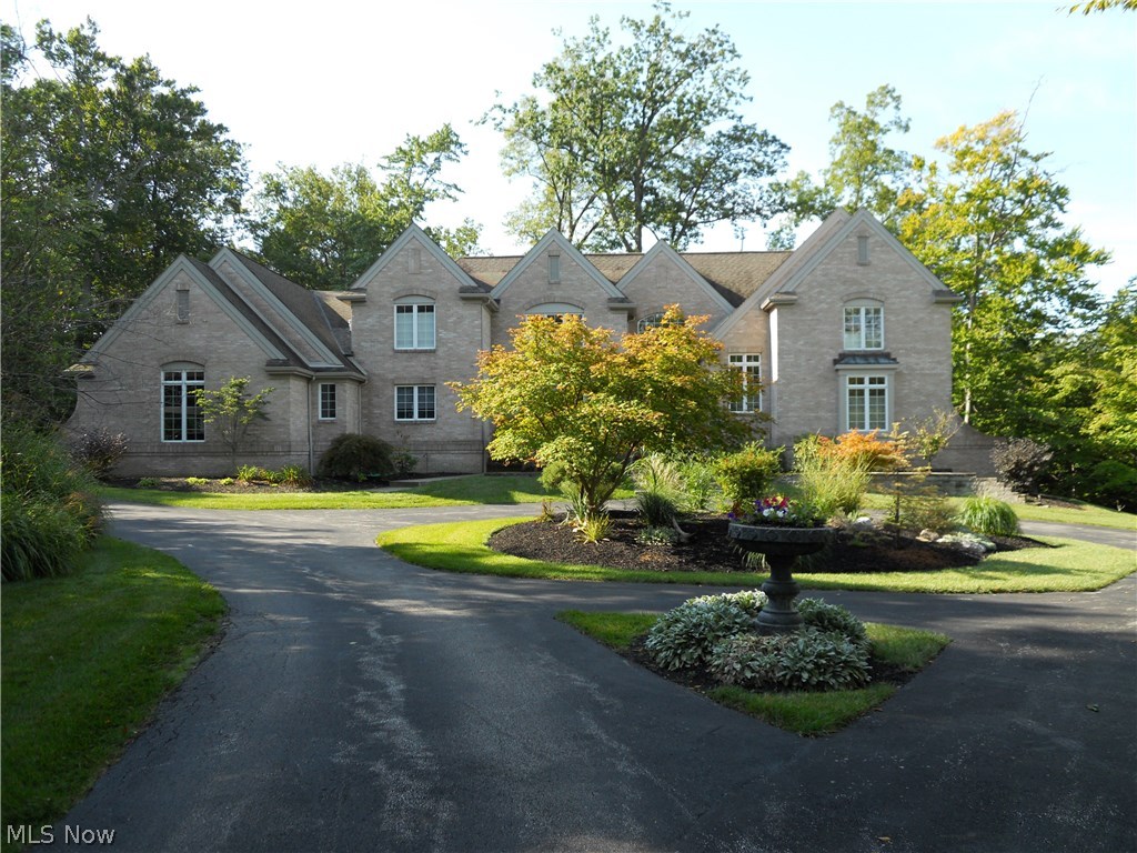 Breathtaking landscaping & circular driveway precede this stunning, full brick colonial in Regency Woods neighborhood. Step through solid wood doors into grand two-story foyer w/marble floors. Large, remodeled kitchen boasts granite countertops, built-in stainless steel appliances, ample cabinetry & walk-in pantry. Breakfast nook features vaulted ceilings & surround windows overlooking wooded 3 1/2 acre yard. Sliding glass door leads to deck. Kitchen opens directly to spacious, two story family room w/vaulted ceilings, wall of windows & upscale fireplace surround. French doors lead to deck, making entertaining a breeze. Hickory wood floors & crown moulding throughout. Formal dining room boasts wainscoting & wallpaper. French doors lead to living room w/vaulted ceilings, hardwood floors & wall of windows, bathing the space in sunlight. First floor executive study paneled in regal Cherry stained wood & features two sets of French doors & custom built-in bookshelves. Luxurious, first floo