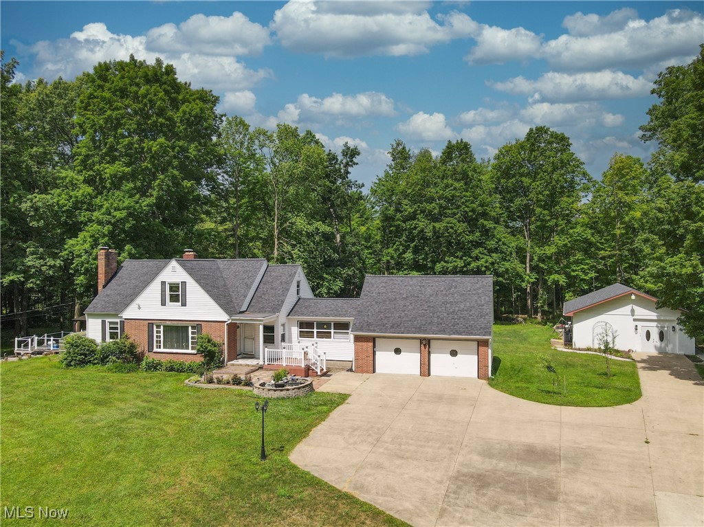 Hidden Gem in Hudson City School District! Tucked away on 2.37 beautiful acres, this unique property offers space, charm, and endless possibilities. The main home features 4 bedrooms, including a convenient first-floor primary suite with a beautifully updated bath. Upstairs, you’ll find three additional bedrooms and a stylishly updated full bathroom. The heart of the home is the spacious eat-in kitchen with granite countertops, stainless steel appliances, and plenty of room for gathering. The cozy living room boasts a fireplace, perfect for relaxing evenings, and a versatile bonus room off the garage can serve as a sunny mudroom or a bright sitting area. A half bath completes the main level. Downstairs, the partially finished basement offers additional living space with a second fireplace, plus a separate laundry area with washer and dryer included. Step outside to discover the incredible detached guest house, complete with its own kitchen, full bath, and generous storage—ideal as an in-law suite, rental opportunity, or private home office. Multiple decks provide great outdoor entertaining areas, and the large backyard features raised garden beds, a storage shed, and room to roam. This one-of-a-kind property blends function, flexibility, and location—Roof/Siding- 3 years old, Water Tank- '20/'21