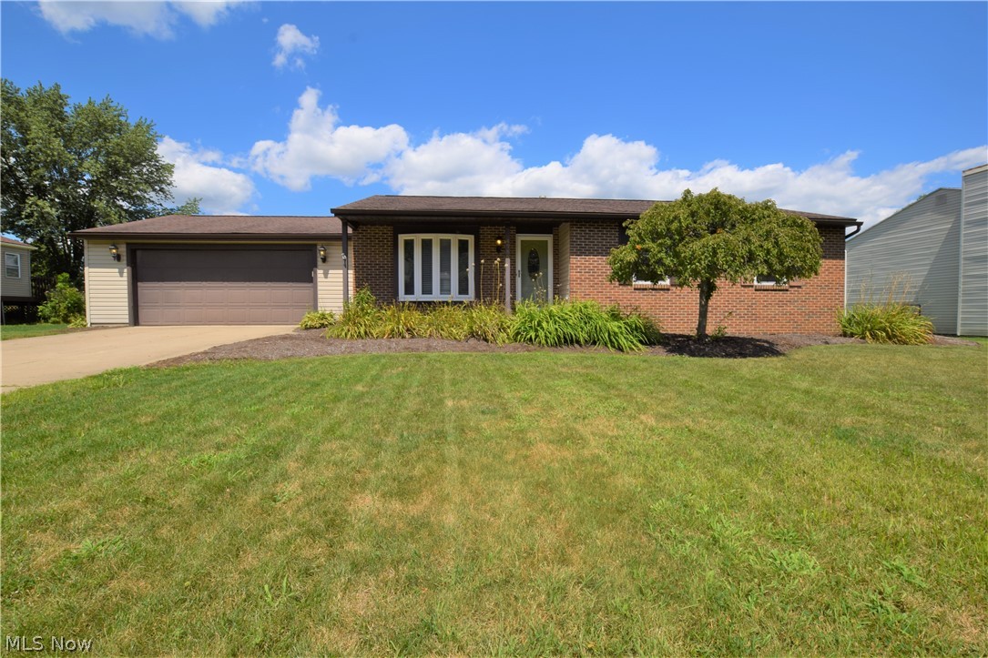Welcome to 4755 Wildflower Drive! This gorgeous 3-bedroom, 2-bathroom brick ranch located within Green Local School District is completely remodeled. Step into the front door and immediately fall in love with the open floor plan. The beautiful vinyl plank flooring stretches throughout the main level. The kitchen has a convenient breakfast bar, gorgeous granite countertops, and spacious pantry/cabinet storage. A Cathedral ceiling with skylights hangs over the kitchen and living room areas. All three bedrooms are nicely sized. Both bathrooms were recently remodeled from the studs. Master bathroom has a spacious tiled shower with a large sliding glass door. The partially finished basement with new bamboo hardwood flooring adds 459 square feet of space to this lovely home. Attached two-car garage has cabinetry and workbench. Spacious backyard includes a brick patio with an open covering and a built-in fire pit. All appliances included with home. Value updates include: H20 Tank (2010), Furn