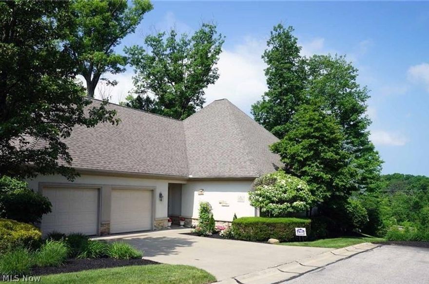 NEW PRICE!!!This free standing ranch condo Lifestyle Community lives like a castle on a private wooded estate in the country with sweeping views and even a babbling brook below!~  FLEXIBLE FLOORPLAN with over 3400 FINISHED sq. feet allows for the conversion of first floor den into a 3rd bedroom or there is LOADS of room in the WALK OUT lower level.    Large open concept foyer leads to the expansive first floor with full wall windows, stone fireplace and access to outdoor space from both the den and the great room to bring nature and relaxation insdie.  The first floor has everything you need on one level including a washer and dryer hook up in huge pantry that can be converted.  Granite counters in the kitchen with extra bar seating.  Bamboo floors in the great room and hardwood in the master.  Enjoy holidays in the full size dining area with ambient lighting.  The master suite is spacious with ample closet and a wall wardrobe.  Attached is the Den with more built ins for desk space an