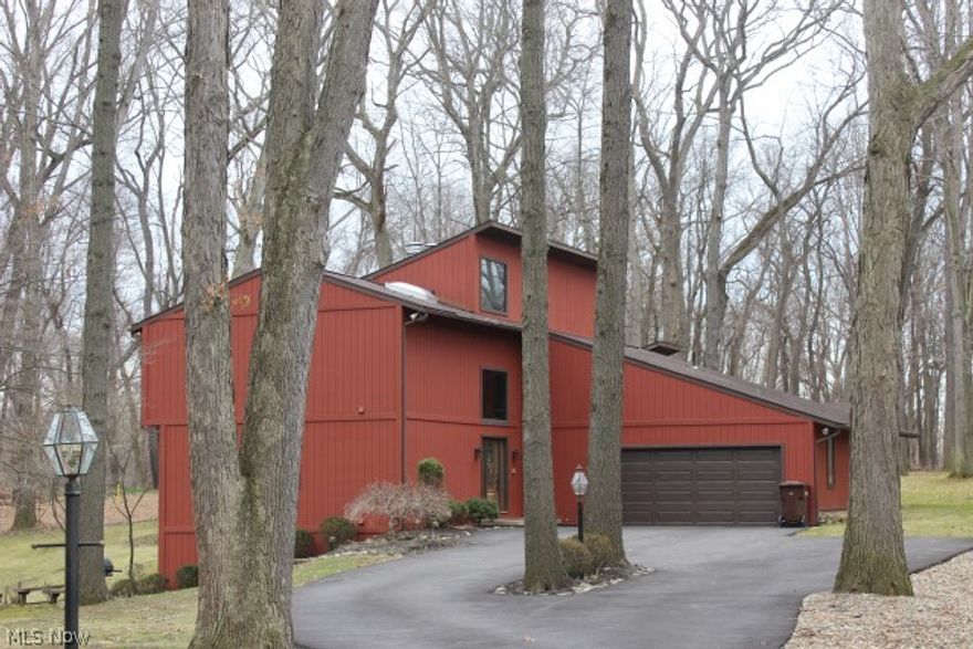 Wow!! Outstanding 4 bedroom, 4 bath contemporary w/3 fireplaces on 1.06 acre cul de sac lot, approx. 3380SF including finished walk out lower level & 3 car garage (one side tandem)* 2 story entry w/beveled glass door & sky lights* Vaulted great room w/gas or wood burning brick fireplace, wood like laminate, sky lights, built in cabinet & atrium door to deck* Vaulted living room w/stove wood burning fireplace, newer Pella atrium door to balcony/3 season sun room & open to formal dining room w/slider to sun room- both rooms w/wood like laminate floor* 1st floor office & guest bedroom (bedroom w/private access to full bath)* 3 season sun room  wrapped w/windows, wood like floor & access to partially covered deck* Kitchen w/ceramic floor, oak cabinets, island w/Jenn Air burner tops, double ovens, refrig & new dishwasher* Master bedroom w/walk out closet & private access to bath w/sky light* Rec Room w/conversation pit w/fireplace, wet bar & slider to brick patio* Oversized tandem garage w/