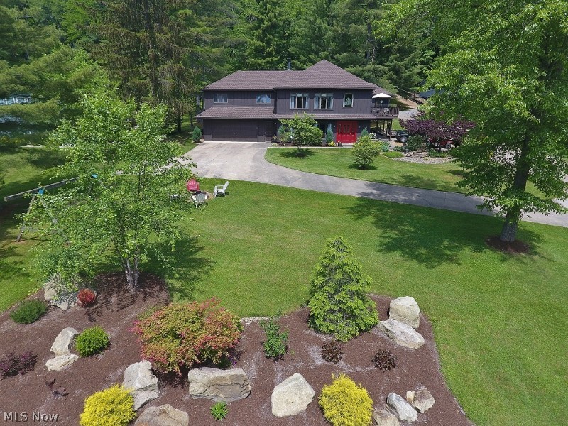 Stunning 5 Bedroom, 3 Bath lake view home in the North Shore community on a beautiful spacious lot. Your prvt dock is a easy walk across the street for your nautical toys to enjoy 1540 acre Atwood Lake. This 2nd row treasure has been meticulously maintained & includes an impressive list of recent updates including a beautiful kitchen w/ granite countertops & tile back splash, LVP flooring throughout the kitchen, dining area & ground level living room. The ground level also provides 2 bedrooms & a full bath with an oversized tiled shower. The upper floor provides a large great room w/ a stone gas fireplace, dry bar with mini fridge, access to a large lake view deck & large windows with impressive lake views. The master suite provides private access to a screened porch, full bath & even a sauna. 2-3 additional bedrooms & a 2nd full bath complete the upper floor. 2 car attached finished garage, attached utility garage & a shed provide an abundance of storage. 3 community beaches offer fam