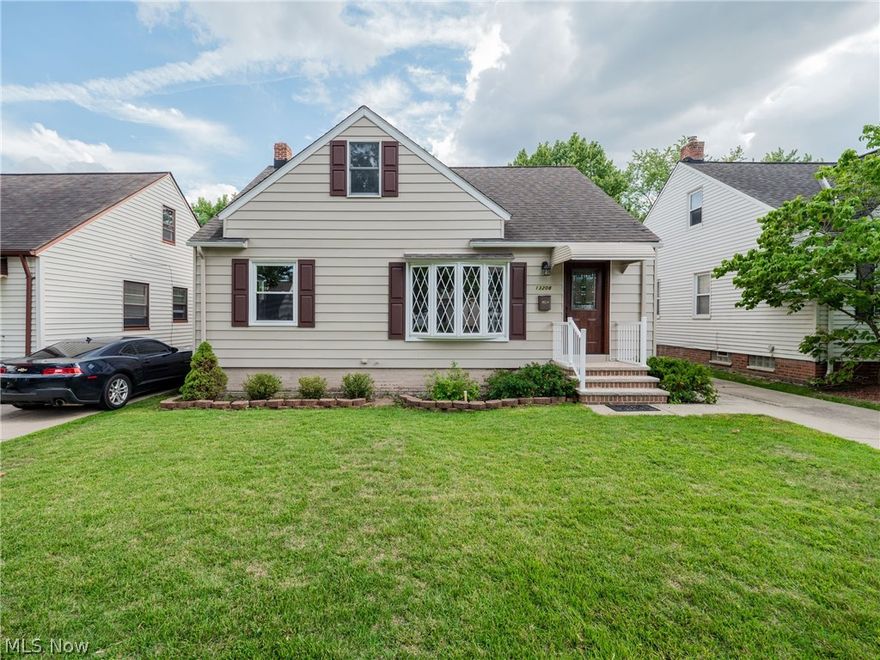 Great curb-appeal! Move-in ready! This charming 3 bedroom, 1.5 bath, cape cod home in Garfield Heights will let you unpack and enjoy- RIGHT AWAY! All of the big things have been done for you! As you enter the newly updated front door you will find a spacious, open-concept floor plan with large living room, renovated kitchen with island and space for table, as well as a cozy enclosed patio off the kitchen. The first floor also boasts a sizeable bathroom with double vanity, shower/tub combo AND a free-standing shower! Two ample-sized bedrooms with hardwood floors complete the first floor. Upstairs you will find a beautifully finished owners suite with newly installed carpeting, a huge walk-in closet and half bath! The space is large enough for many furniture arrangements. The unfinished, waterproofed basement will house your laundry area and is ready to be finished or used as-is for storage. Outside you will find a fenced-in backyard with a detached one-car garage. Freshly painted throug