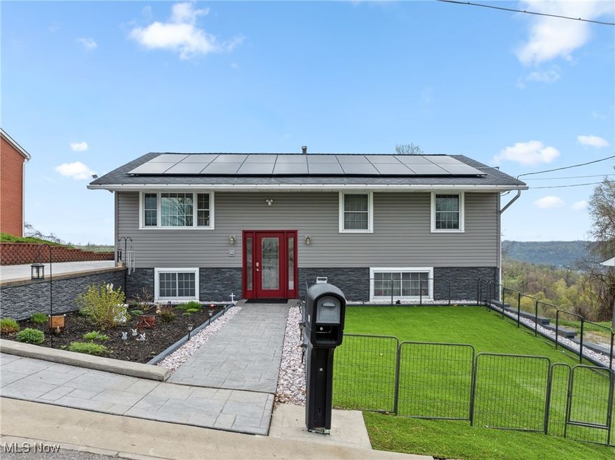 WOW!! Hello Martins Ferry! Have you been looking for the perfect maintenance free home?! 16 Hillcrest Drive is for you! As soon as you pull up you will notice upgrades galore; from a beautiful landscaped exterior, new vinyl siding, stamped concrete driveway, and new solar panels (Providing the houses electric!). Step inside and you will find plenty of room for the whole family. The main floor features a large living room with a vaulted ceiling and panoramic views of the beautiful hills. The wrap around deck continues the indoor outdoor living space making this the PERFECT spot for summer entertaining. Also, on the main floor is an eat in kitchen with new appliances, dining room, three bedrooms, and one bathroom. Step down to the lower level and enjoy an over sized family room, full bathroom, fourth bedroom, and laundry room. Also downstairs is the one car garage and large workshop equipped with all the tools for a handyman's dream come true! If the expansive deck was not enough, the most perfect covered porch awaits you for your morning coffee overlooking the unobstructed views of the valley. Also around back is a patio for relaxing and entertaining, a fire pit, and new shed! All of this nestled in a quiet, highly desired neighborhood right outside of town. RUN! This beauty won't last long.