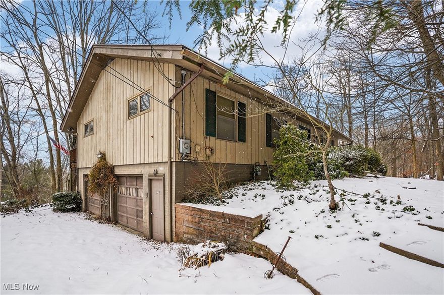 Beautiful setting with a peaceful view overlooking the Cuyahoga Valley. Wonderful contemporary home with vaulted ceilings, great for entertaining. Large open foyer entry. The kitchen has granite countertops, tiled backsplash and sliding door opens to the deck. Living room, dining room and fireplaced family room all have vaulted ceilings. 3 separate sets of sliding doors open to the expansive rear deck that extends the full length of the home. Main floor has 3 bedrooms. The larger ensuite bedroom has a vaulted ceiling, bath with a jetted tub and separate shower. On the lower level is large open space with a second kitchen, a full bath, 4th bedroom, second family room with wood burning fireplace. The family room opens to a large concrete patio with a big view. The 2 car garage is oversized. Perfect setting to enjoy nature and wildlife while relaxing outside on your deck or patio.