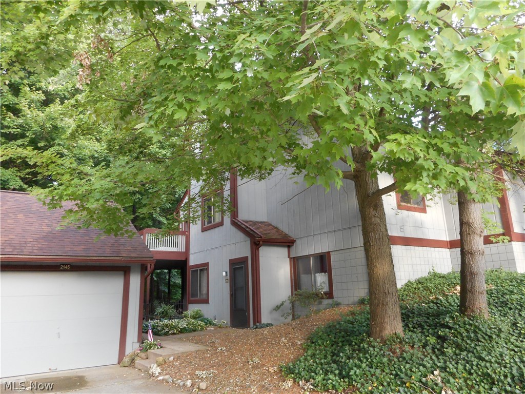 Very motivated seller! Awesome contemporary condo with wooded views! This 2 bedroom, 2 full bath home offers an open floor plan with a first floor laundry, an applianced kitchen and dining area. The vaulted great room boasts a wood burning fireplace and skylights that provide lots of natural light. A convenient and spacious first floor bedroom features a walk-in closet. On the second floor a large loft bedroom has an additional full bath with skylight and a walk-in closet. This property offers 1552 of living space and has lots of storage. There's even pull down storage in the garage. Located close to Cuyahoga Valley National Park and Portage Crossing restaurants and shops.