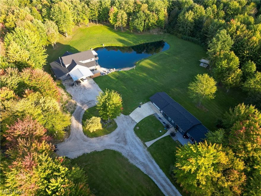 2 for the price of 1! Set on 5+ truly-parklike acres this master craftsman styled 5 bedroom 2 bath home is so unique in every way you'll have to see it to believe it. Highlighted by the H-U-G-E 20 x 35 great room that features a wall of windows that overlooks the stocked pond and accentuates the beauty of the wooded wildlife refuge. The open floor plan makes for wonderful entertaining as the kitchen blends easily into the design. 3 - 1st floor bedrooms, Jack N Jill first floor bath, Built-in loft-styled beds, private master suite w/office and a walk-in closet, a fantastic 2nd story family room complete with fireplace, wood floors and a private entrance to a second floor covered balcony. Heated 24 x 27 attached garage and a heated and attached 27 x 16 workshop. 24 x 28 carport with 10 ft ceiling height, private beach and overflowing with character! Additionally there is a 3 bedroom 2 bath ranch with 2 car attached garage and it's own septic system on the property. Ideal for a guest house, income property or whatever your imagination can conjure up! Impeccably cared for throughout - Come Fall in Love!