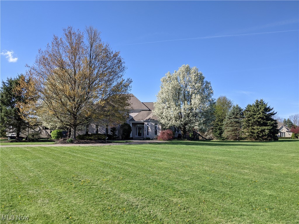 This beautifully renovated 4-bedroom home sits on a generous 1-acre lot, offering a perfect blend of comfort, style, and functionality. The spacious open-concept kitchen features abundant cabinetry and a massive island with seating, flowing seamlessly into a cozy living room anchored by a striking stone fireplace and space for a large-screen TV. The first-floor primary suite includes a luxurious ensuite bath and walk-in closet, while the main level also boasts a formal dining room and a dedicated office with custom built-ins. Upstairs, you'll find a private bedroom suite with its own bathroom, plus two additional bedrooms connected by a Jack-and-Jill bath. The finished basement expands your living space with a game and rec room, a full home gym, a versatile craft room, and ample storage. Outside, enjoy a spacious backyard with a large deck and room for an above-ground pool, along with a detached 1.5-car garage/outbuilding for all your tools and equipment. Recent upgrades include a whole-house generator (2017) and a brand-new roof (June 2025). The hot tub and trampoline are negotiable, adding even more flexibility to this move-in-ready home designed for modern living.